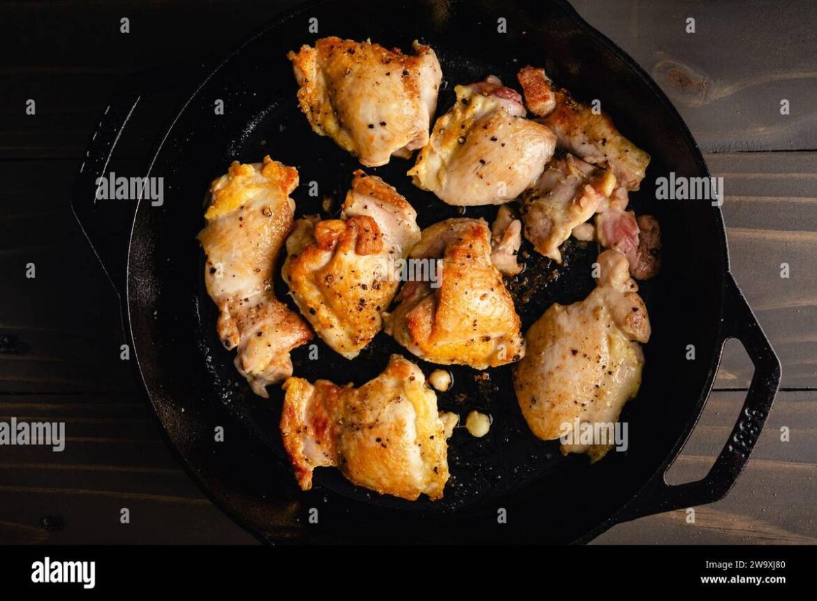 browned-boneless-skinless-chicken-thighs-in-a-cast-iron-pan-pan-seared-chicken-thighs-seasoned-with-sea-salt-and-freshly-ground-black-pepper-2W9XJ80